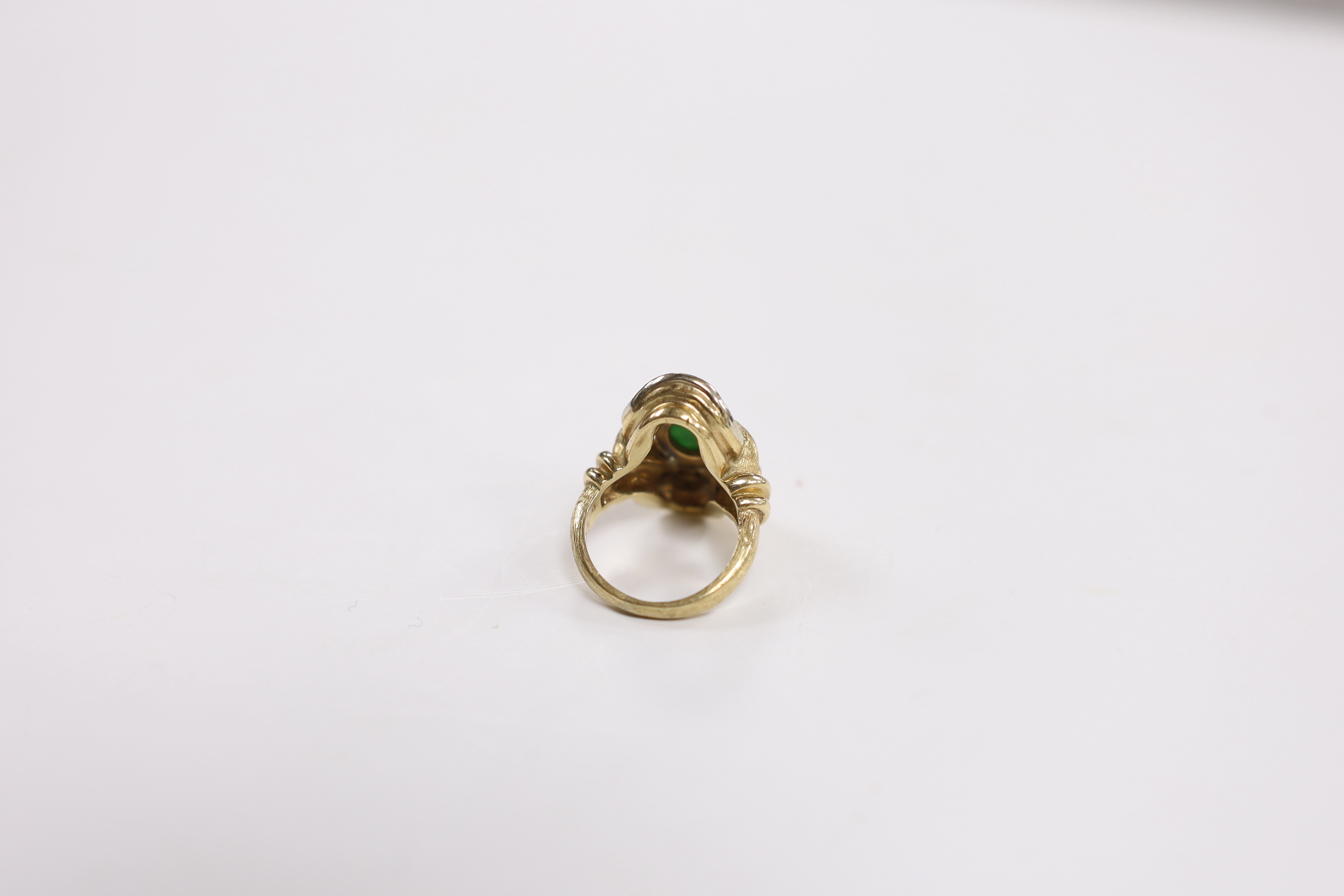 A 14k, oval cabochon jade and diamond cluster set dress ring, size J, gross weight 11.4 grams.